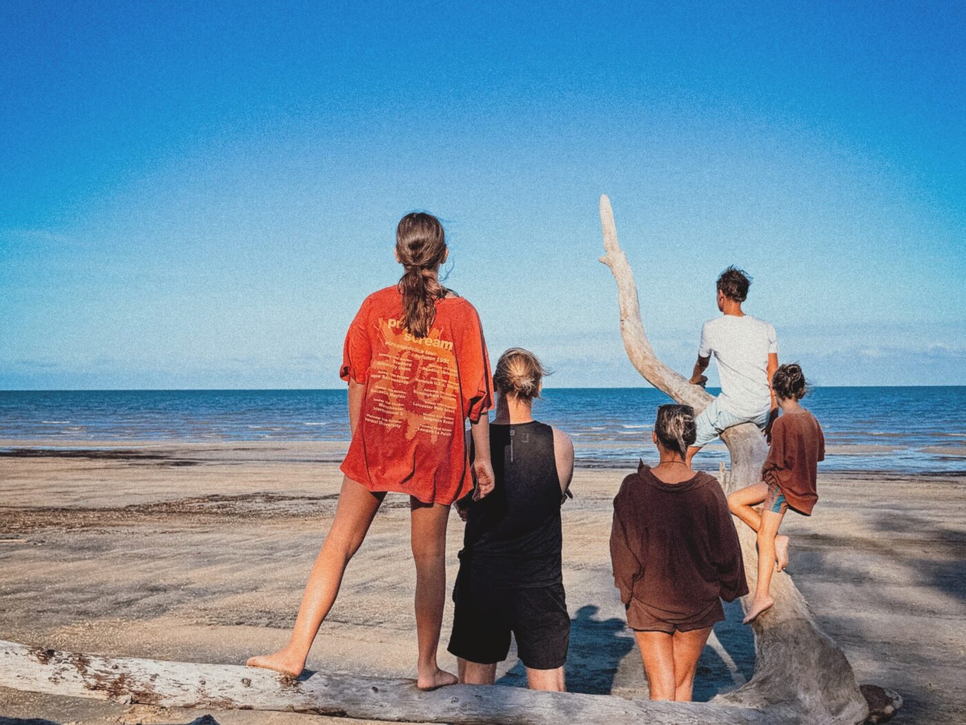 Family of five on the beach looking out over the ocean